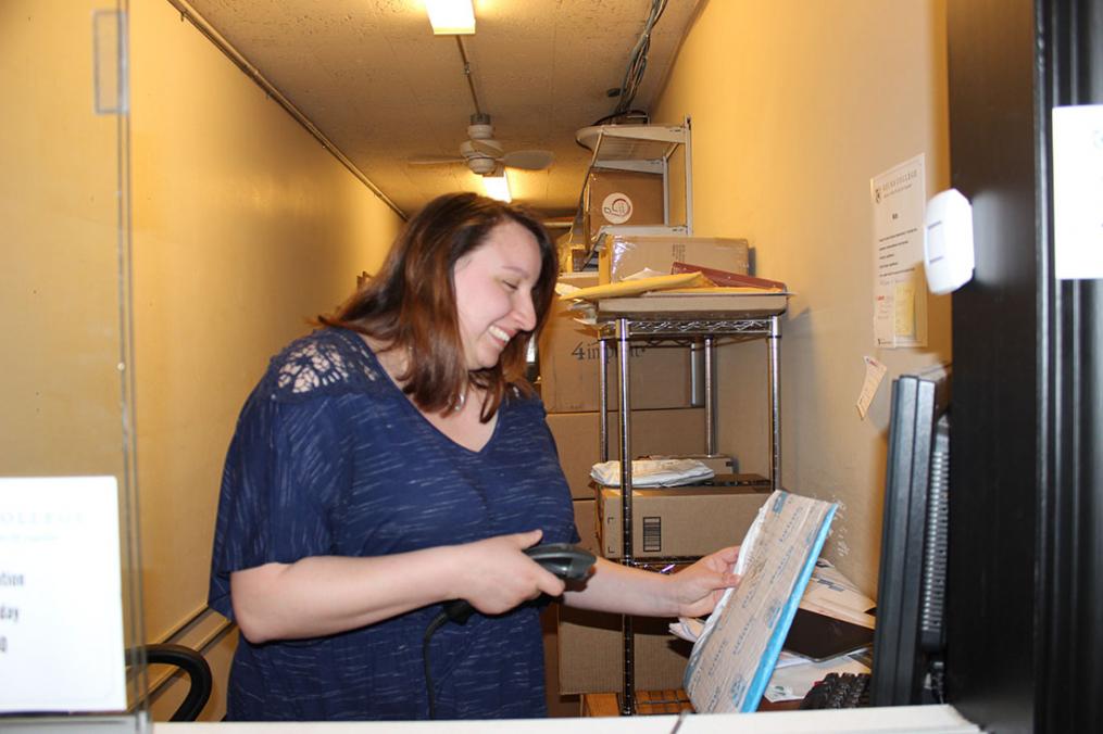 Sarah Martinez '21 scans a package coming into the College's mail room.