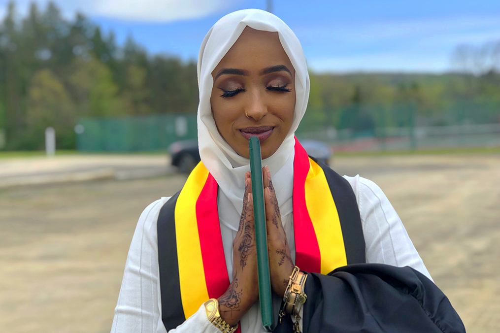 Hani Ali holding her diploma